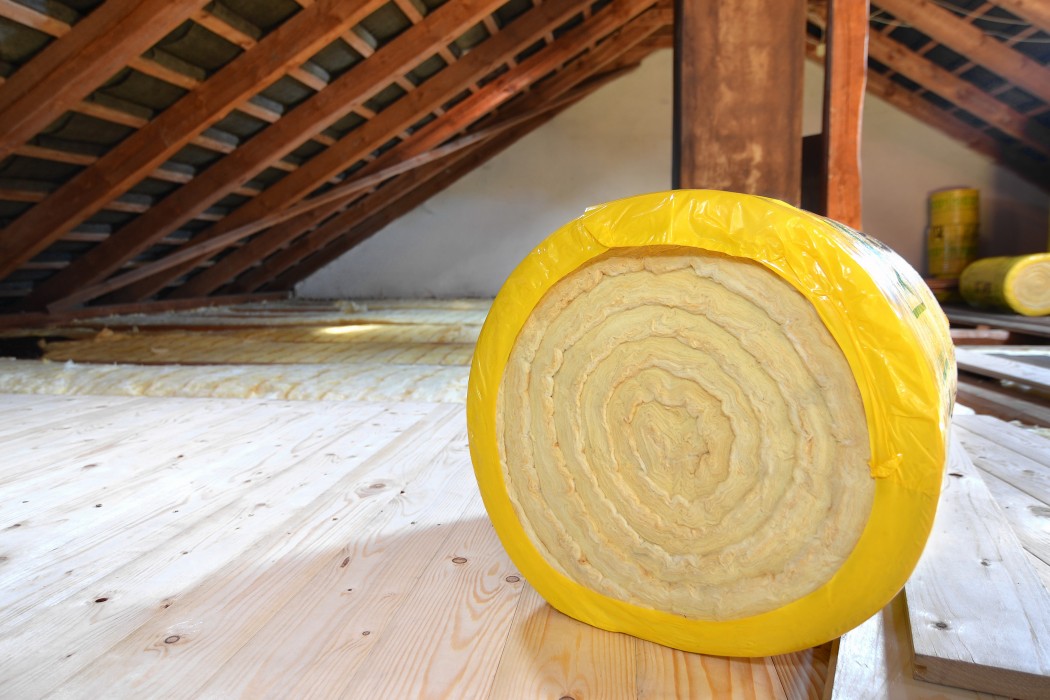 roll of insulating glass wool on an attic floor